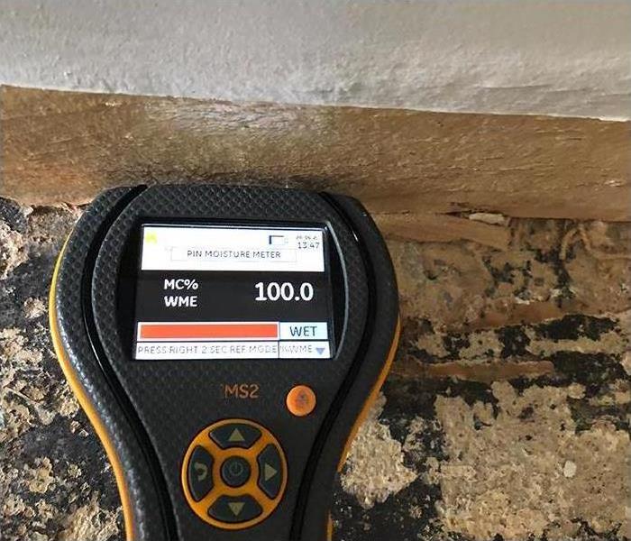 moisture meter reading during water damage investigation