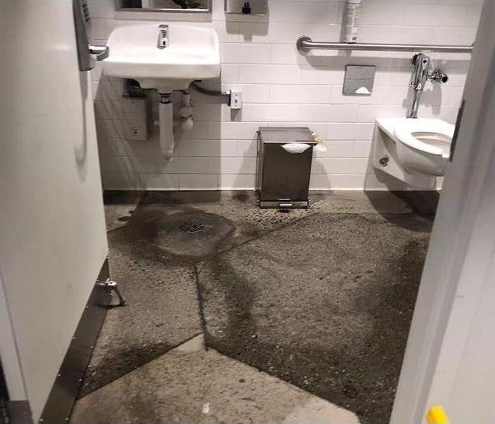 sewage and contaminated water damage to commercial bathroom